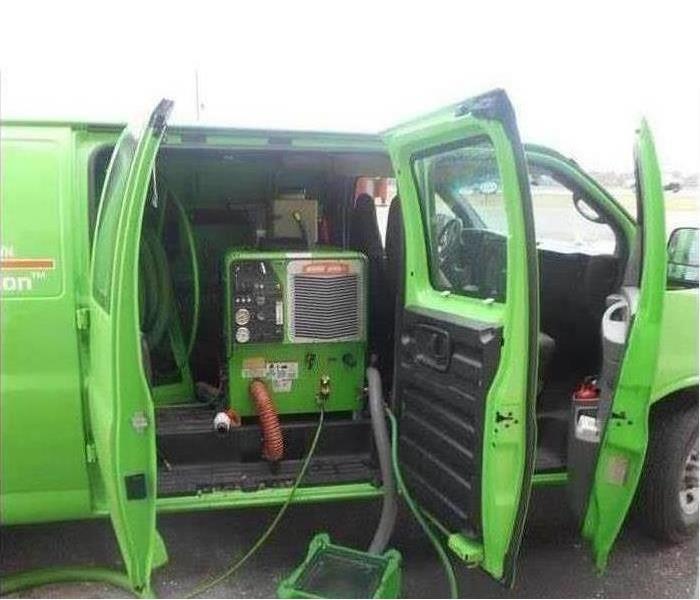 SERVPRO restoration vehicle with doors open, equipment being used